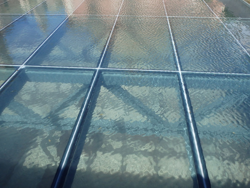 A see through roof covering Roman Ruins.